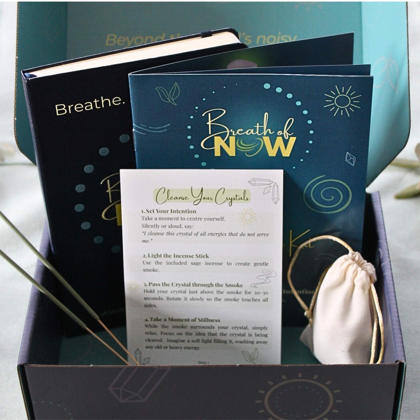 7 Chakra Meditation Kit displayed in an open box, including crystals, journal, guided meditation booklet, sage incense, and cleansing card — complete mindfulness and energy alignment set.