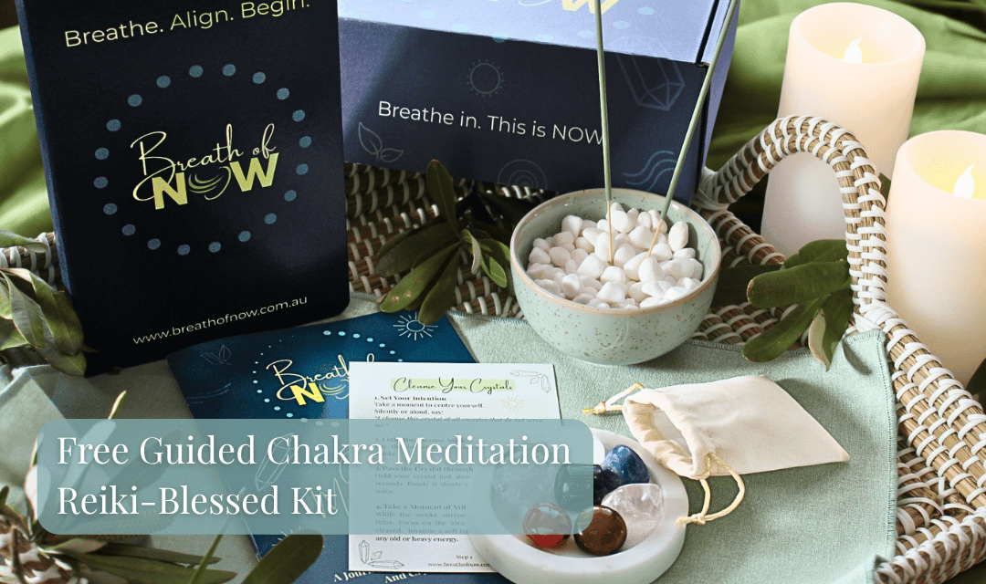 7 Chakra Meditation Kit with crystals, guided meditation booklet, journal, information card, sage incense, and box on a wicker tray with candles and natural elements — includes free guided chakra meditation audio and Reiki blessing for mindfulness and energy alignment.